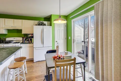 a dining room with furniture and a chandelier