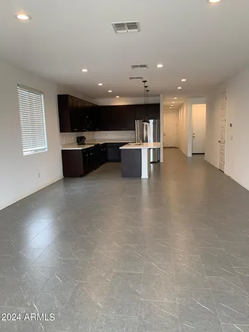 a view of kitchen with stainless steel appliances a refrigerator and a stove top oven