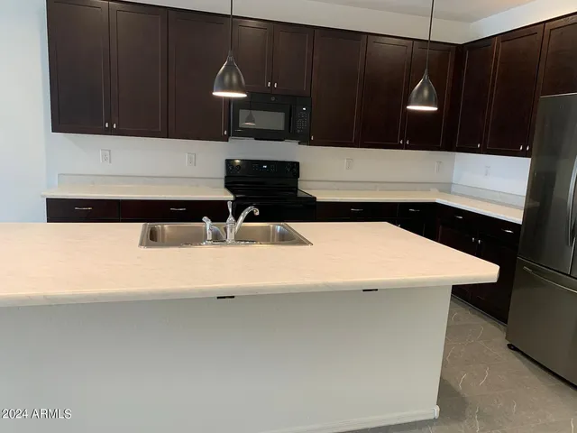 a view of a refrigerator in kitchen