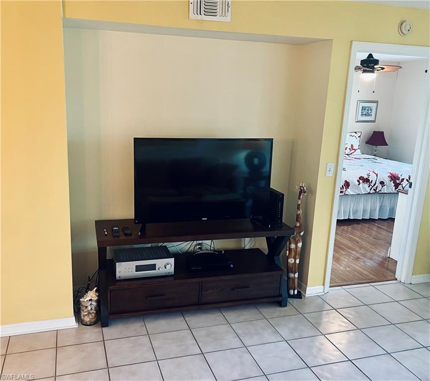 121 Gabriel Circle, Unit 7 Naples, FL 34104 - Photo 11 of 20 Room details with ceiling fan and wood-type flooring