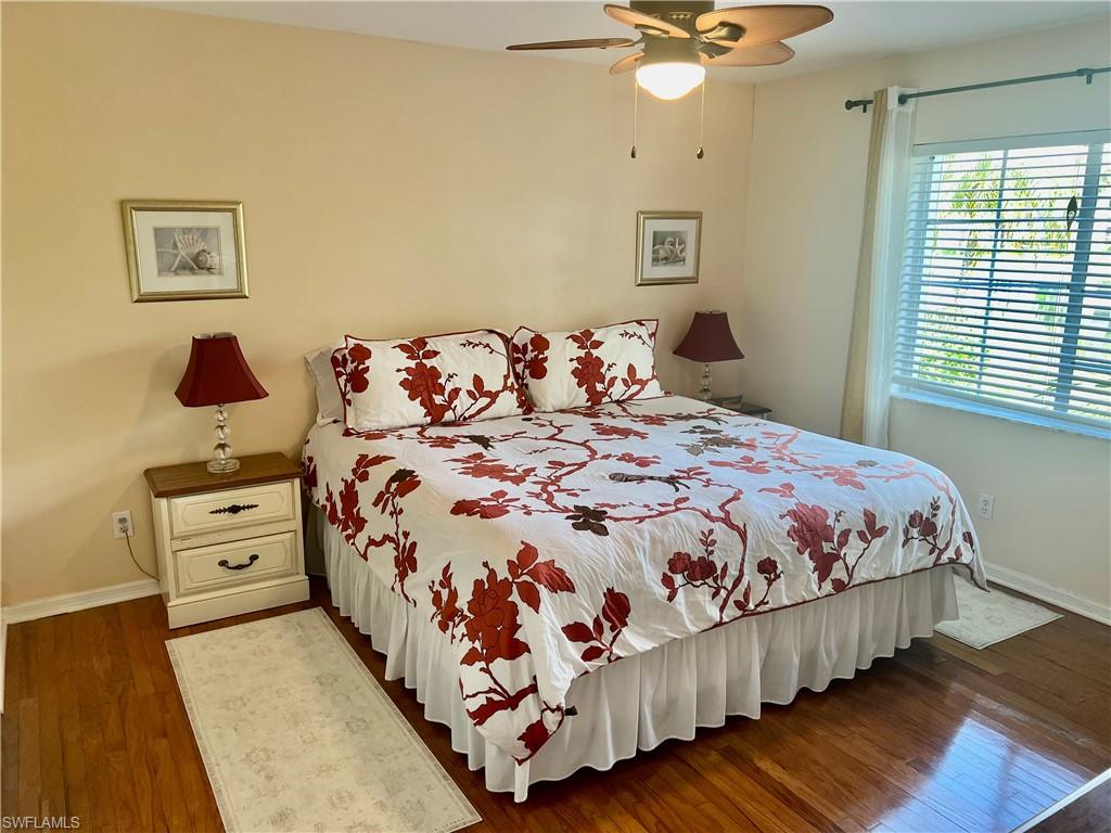 121 Gabriel Circle, Unit 7 Naples, FL 34104 - Photo 12 of 20 Bedroom featuring dark wood-type flooring and ceiling fan