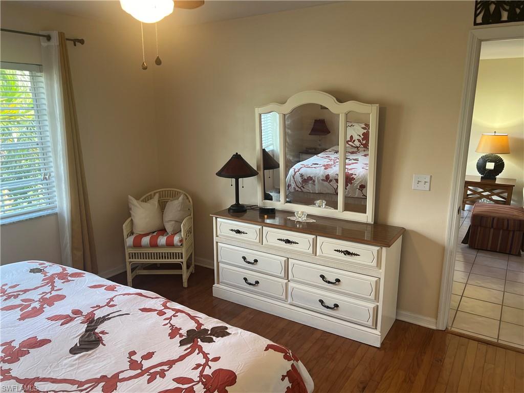 121 Gabriel Circle, Unit 7 Naples, FL 34104 - Photo 13 of 20 Bedroom with dark hardwood / wood-style flooring