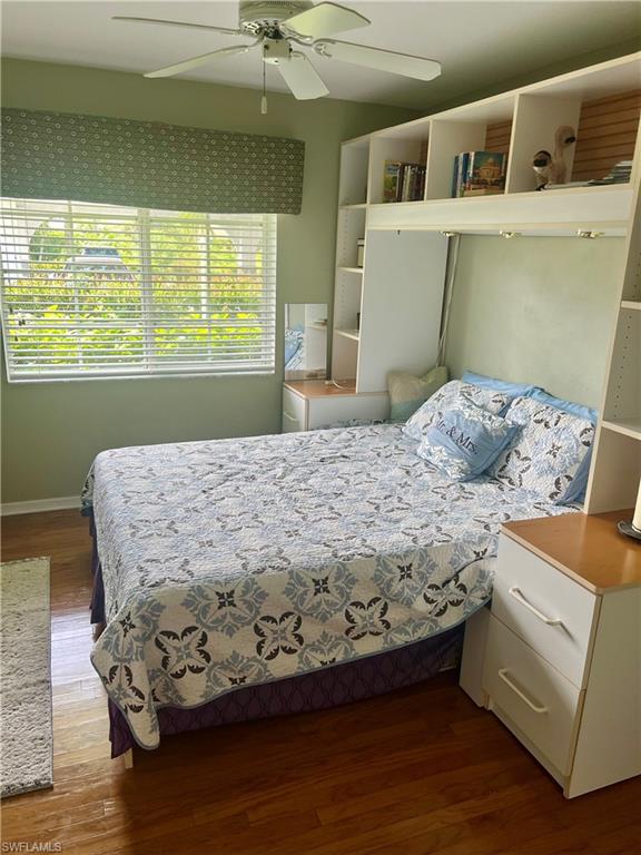 121 Gabriel Circle, Unit 7 Naples, FL 34104 - Photo 16 of 20 Bedroom featuring hardwood / wood-style flooring and ceiling fan