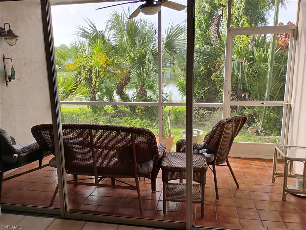 121 Gabriel Circle, Unit 7 Naples, FL 34104 - Photo 20 of 20 Sunroom with a water view and ceiling fan
