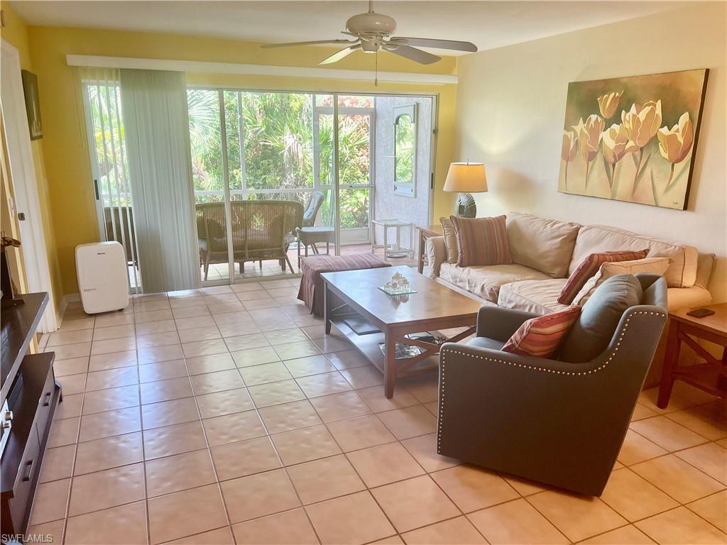 121 Gabriel Circle, Unit 7 Naples, FL 34104 - Photo 7 of 20 Living room featuring ceiling fan and light tile patterned flooring