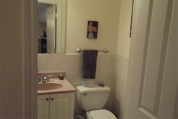 218 Rangeway Road, Unit 283 Billerica, MA 01862 - Photo 12 of 30 a bathroom with a toilet sink and mirror