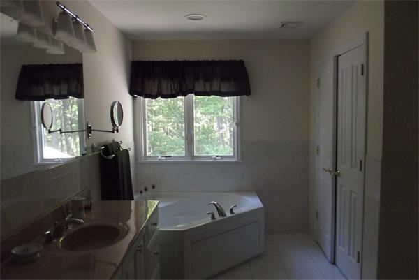 218 Rangeway Road, Unit 283 Billerica, MA 01862 - Photo 17 of 30 a bathroom with a tub sink and window