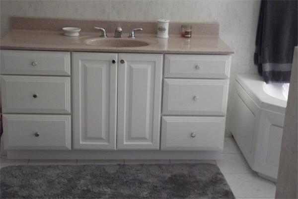 218 Rangeway Road, Unit 283 Billerica, MA 01862 - Photo 18 of 30 a bathroom with a sink and cabinets