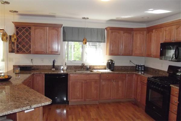 218 Rangeway Road, Unit 283 Billerica, MA 01862 - Photo 4 of 30 a kitchen with a sink stove top oven and cabinets