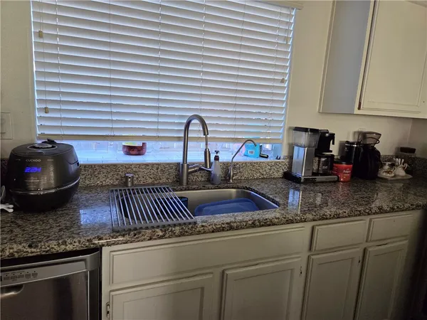 a kitchen with a sink and cabinets