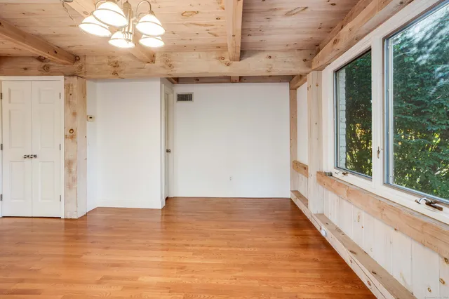 a view of a room with wooden floor and window
