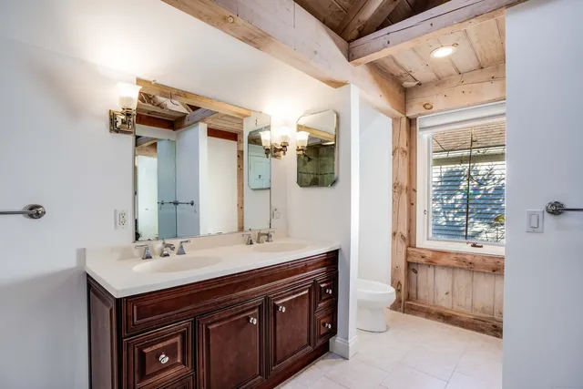 a bathroom with a sink double vanity and a mirror