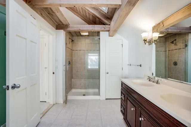 a spacious bathroom with a shower and a sink