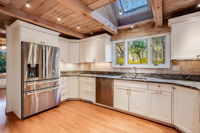 a kitchen with granite countertop appliances cabinets and a sink