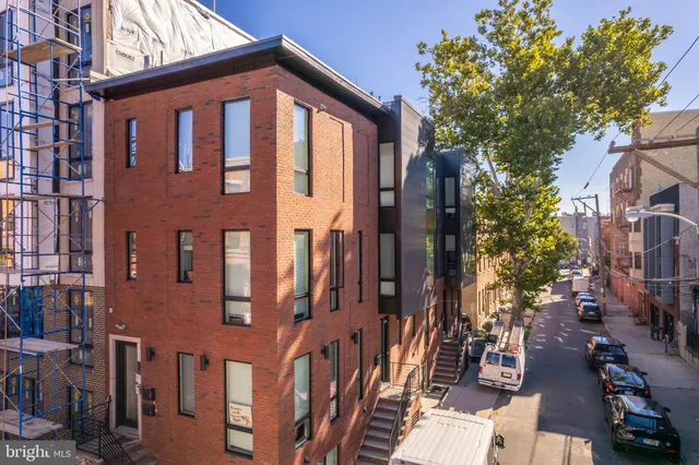 a front view of a building with a yard