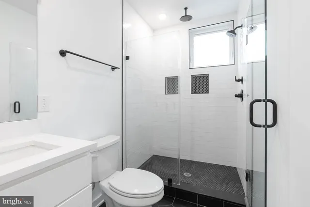 a bathroom with a sink toilet and shower