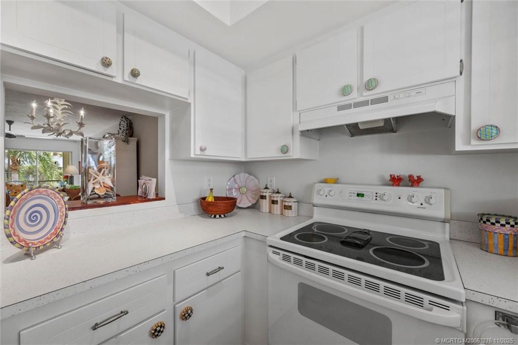 2929 Southeast Ocean Boulevard, Unit 1157 Stuart, FL 34996 - Photo 13 of 26 a kitchen with white cabinets and appliances
