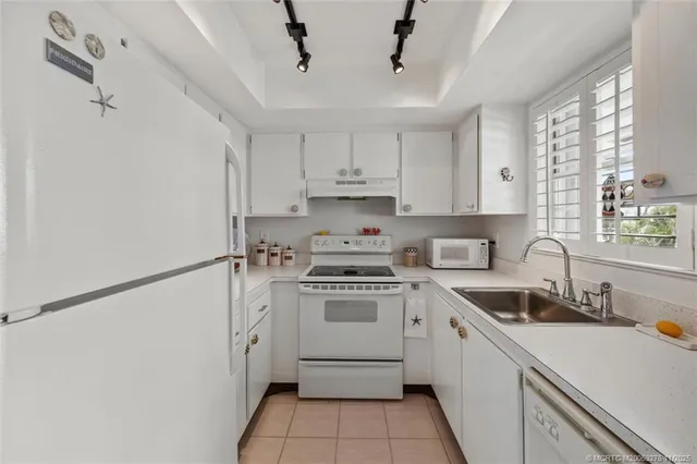 a kitchen with a stove and white cabinets