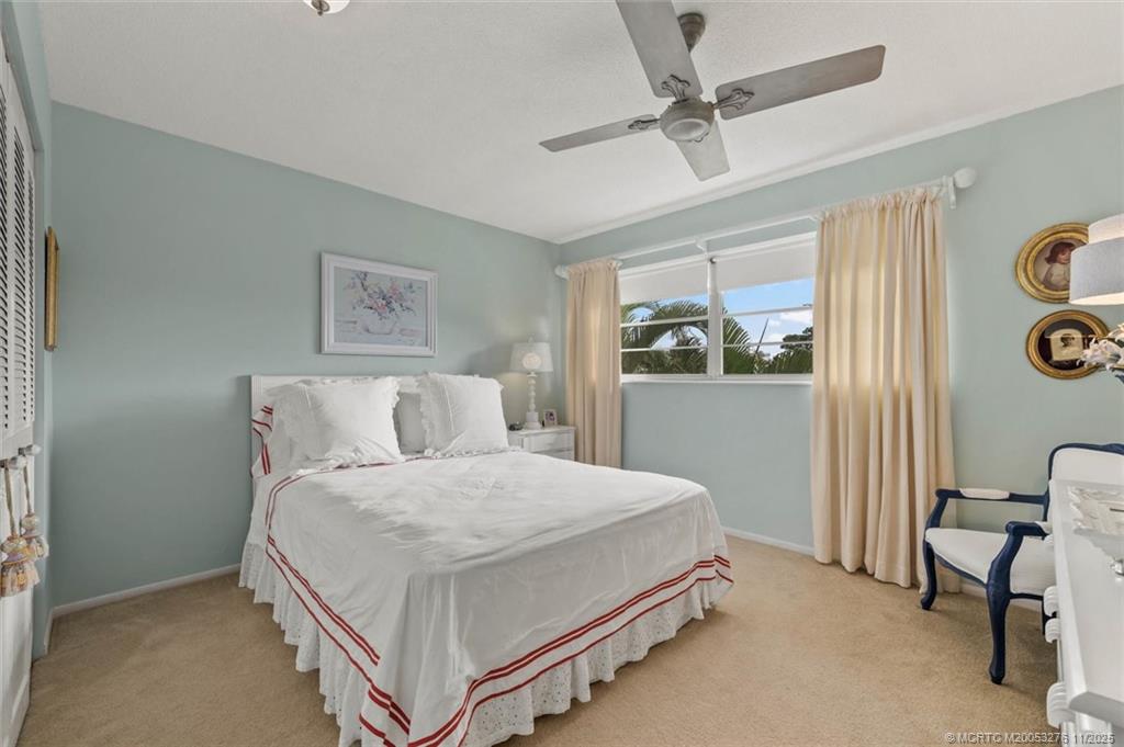 2929 Southeast Ocean Boulevard, Unit 1157 Stuart, FL 34996 - Photo 17 of 26 a bedroom with a bed and a window