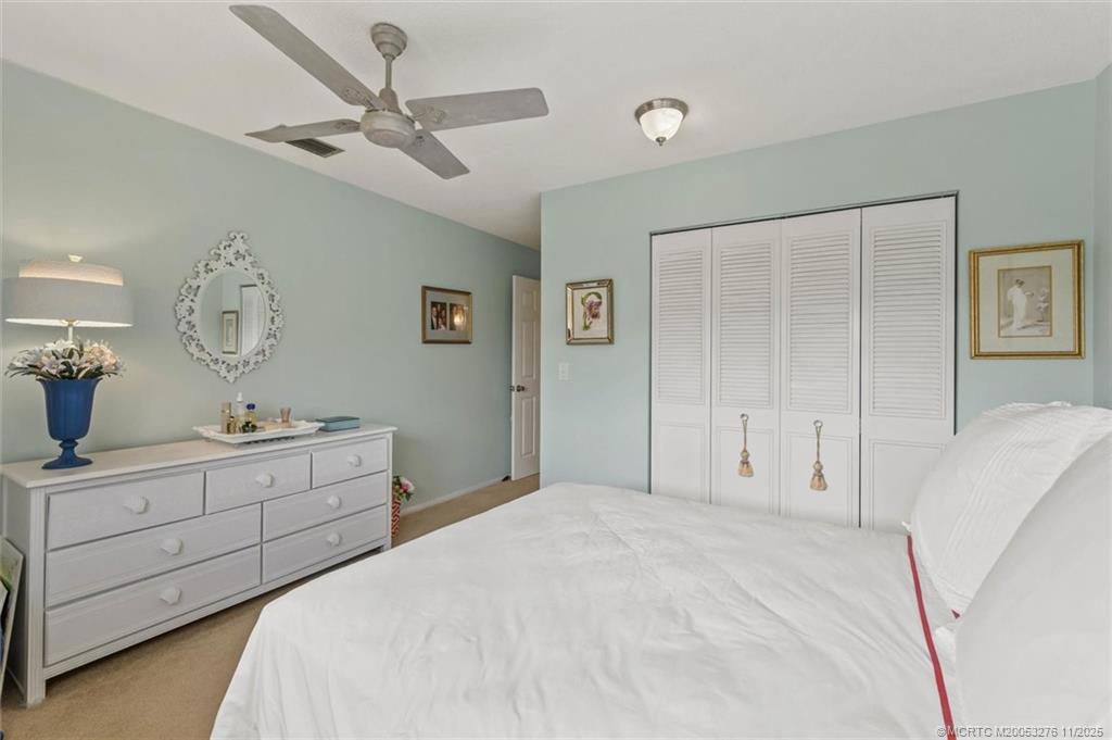 2929 Southeast Ocean Boulevard, Unit 1157 Stuart, FL 34996 - Photo 18 of 26 a bedroom with a bed and a dresser