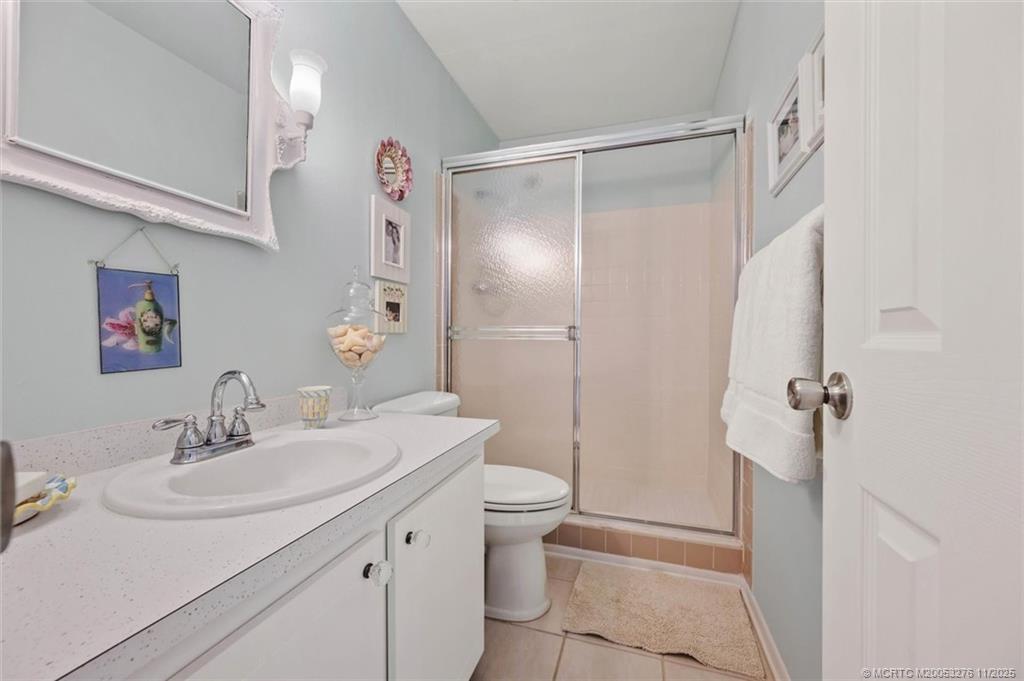 2929 Southeast Ocean Boulevard, Unit 1157 Stuart, FL 34996 - Photo 19 of 26 a bathroom with a sink toilet and shower