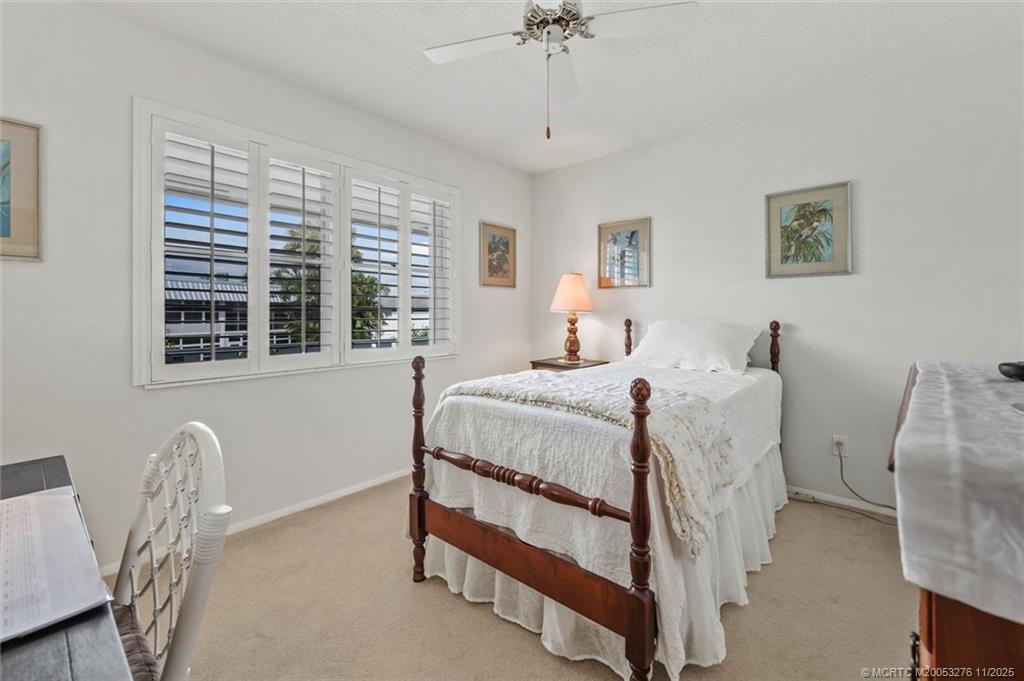 2929 Southeast Ocean Boulevard, Unit 1157 Stuart, FL 34996 - Photo 20 of 26 a bed room with a bed and a window