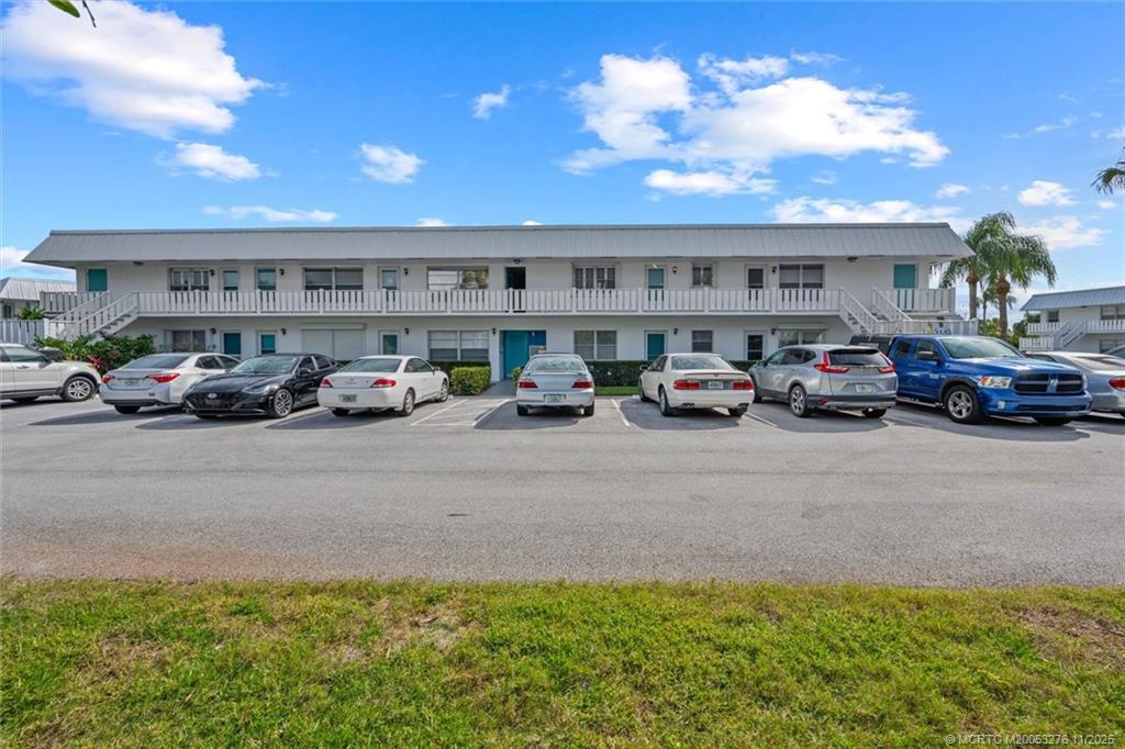 2929 Southeast Ocean Boulevard, Unit 1157 Stuart, FL 34996 - Photo 2 of 26 a cars parked in front of a building