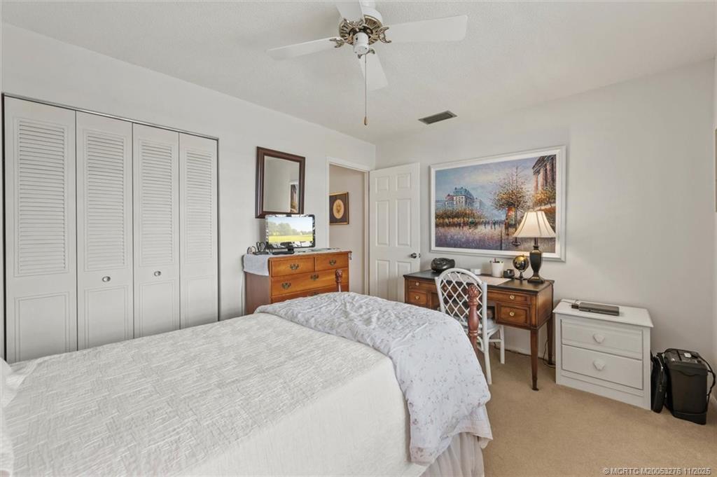 2929 Southeast Ocean Boulevard, Unit 1157 Stuart, FL 34996 - Photo 22 of 26 a bed room with a bed and a chair