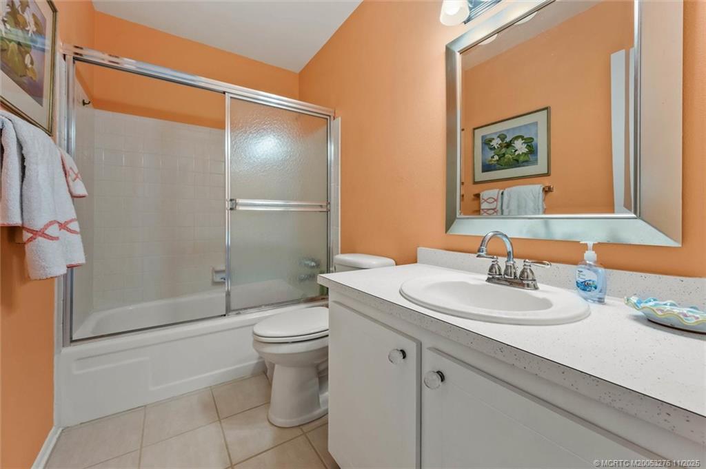 2929 Southeast Ocean Boulevard, Unit 1157 Stuart, FL 34996 - Photo 23 of 26 a bathroom with a sink a toilet and shower