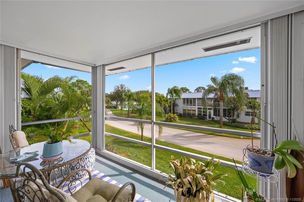 2929 Southeast Ocean Boulevard, Unit 1157 Stuart, FL 34996 - Photo 24 of 26 a view of a porch with furniture and a yard