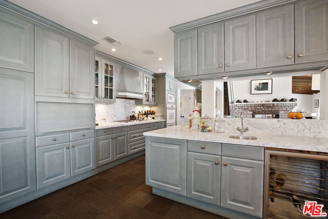 3333 Wrightwood Drive Studio City, CA 91604 - Photo 13 of 33 a kitchen with cabinets appliances a sink and a counter top space