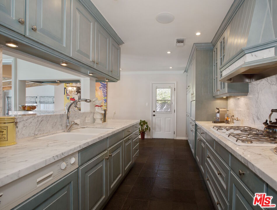 3333 Wrightwood Drive Studio City, CA 91604 - Photo 14 of 33 a kitchen with a sink stove and cabinets