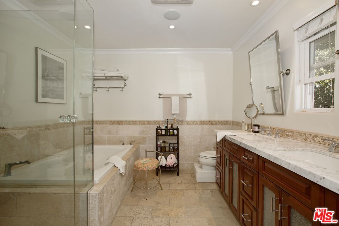 3333 Wrightwood Drive Studio City, CA 91604 - Photo 17 of 33 a spacious bathroom with a granite countertop sink a toilet and mirror