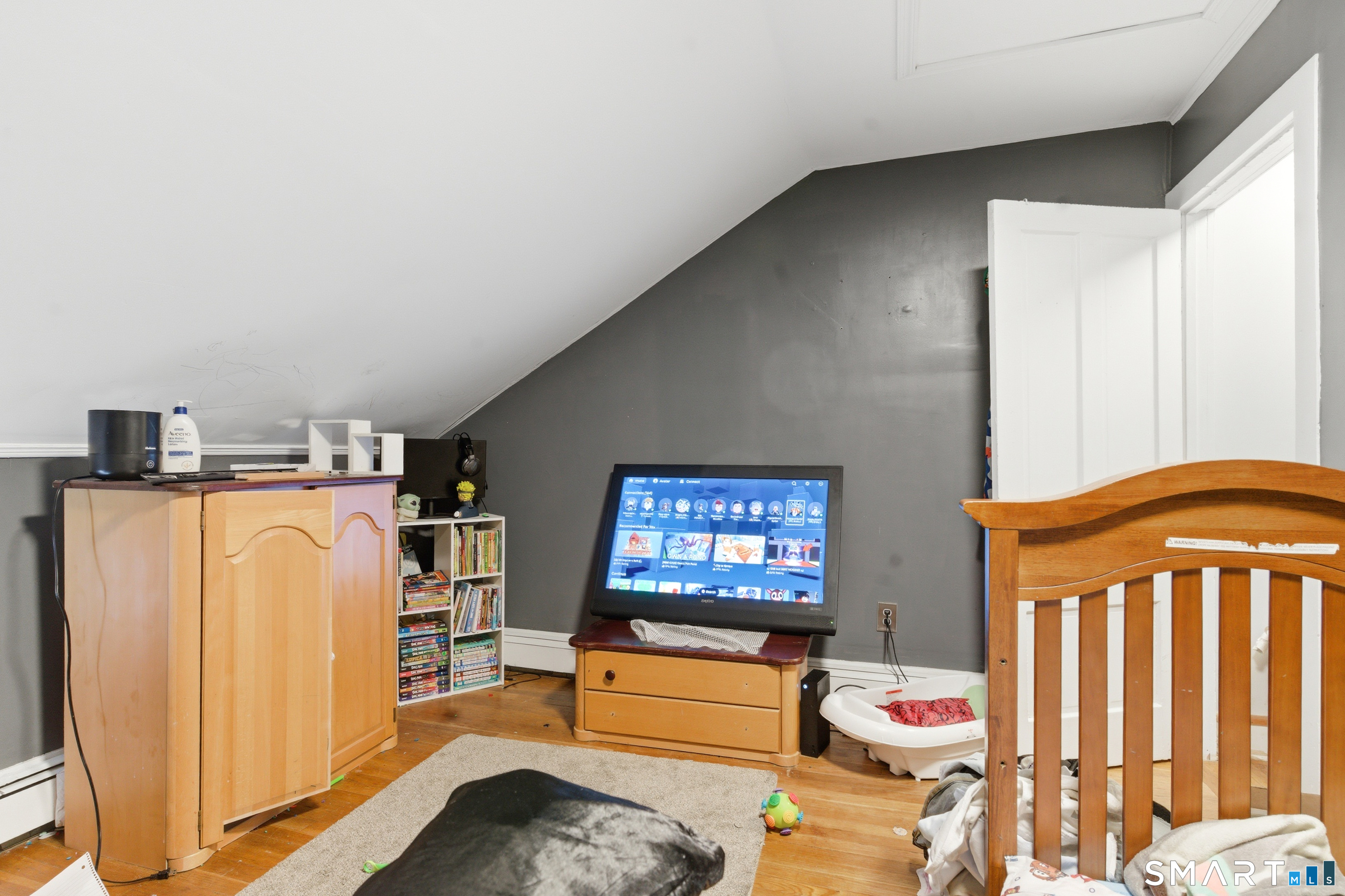 36 Church Street Killingly, CT 06241 - Photo 11 of 39 a bedroom with furniture and a book shelf