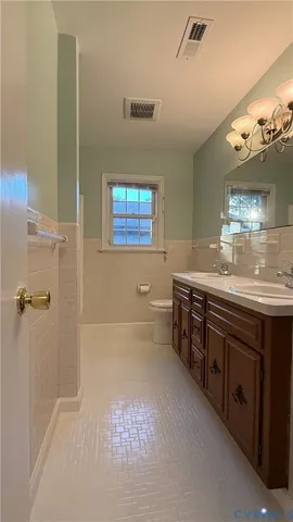 a bathroom with double vanity sink and a mirror