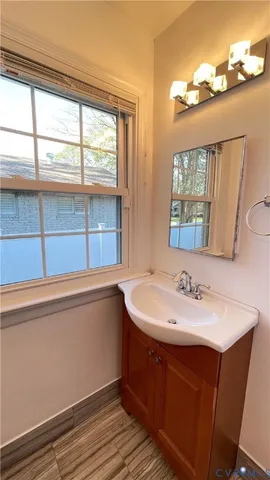 a bathroom with a sink and a large window