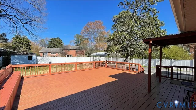 a view of a swimming pool with a patio and wooden floor