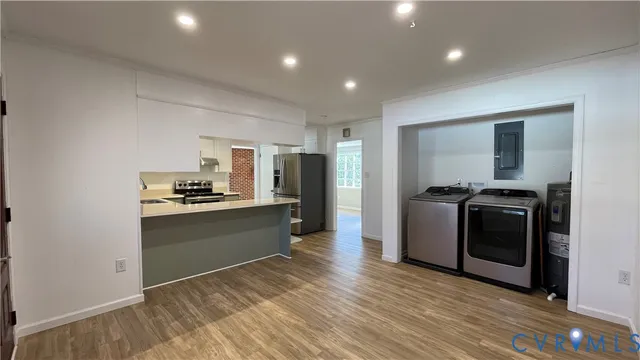 a kitchen with stainless steel appliances granite countertop a refrigerator and a stove top oven