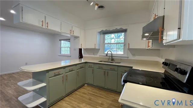 a kitchen with a sink cabinets and window