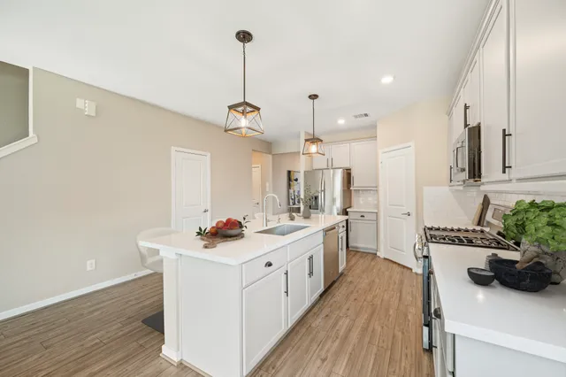 a kitchen with a sink stove and cabinets
