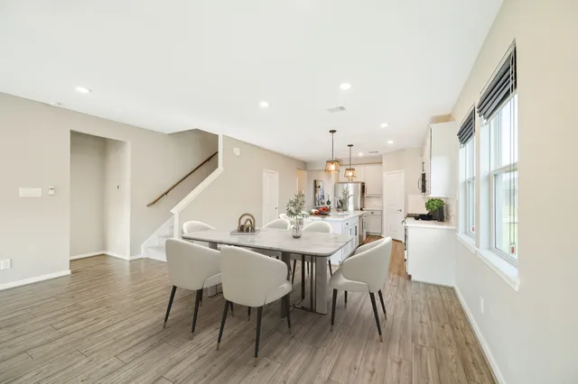 a view of a dining room with furniture and wooden floor