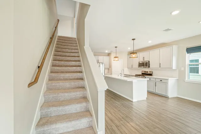 a view of kitchen with sink microwave and stove
