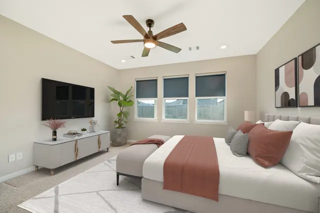 a bedroom with a large bed and a flat screen tv