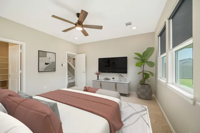 a bedroom with a balcony a bed and a flat screen tv