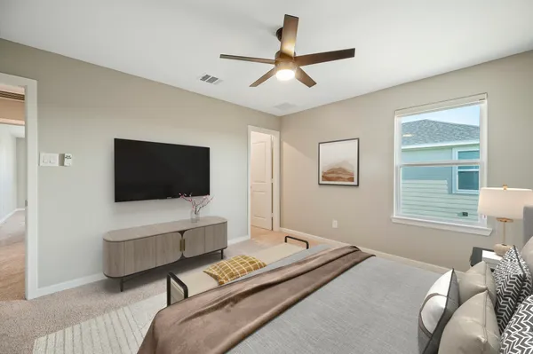 a bedroom with a bed and a flat screen tv