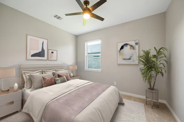 a bedroom with bed and a potted plant