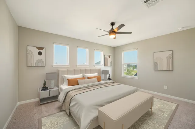 a bedroom with a large bed and a chandelier