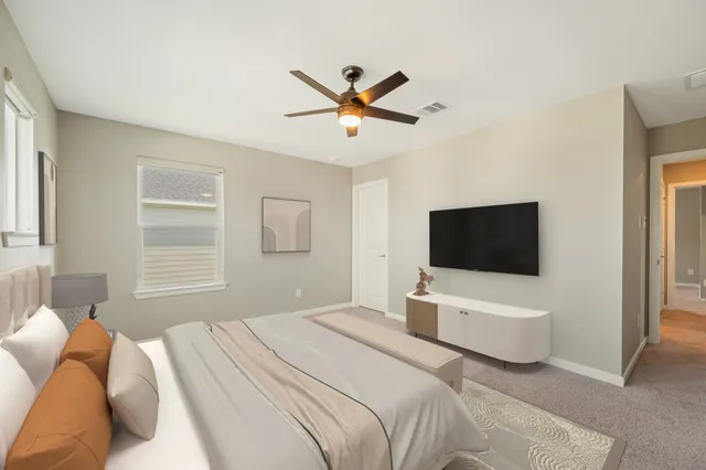 a bedroom with a bed and a flat screen tv