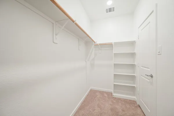 a view of an empty walk in closet