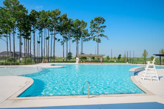 a view of a swimming pool and a yard